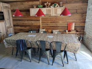 a table in a room with chairs and red lights at 3 Biches in Font-Romeu-Odeillo-Via