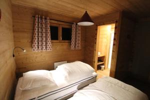 a bedroom with two beds in a wooden room at 3 Biches in Font-Romeu-Odeillo-Via