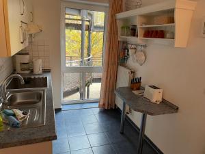 a small kitchen with a sink and a window at Seeblick Wohnung 115 in Ostseebad Koserow