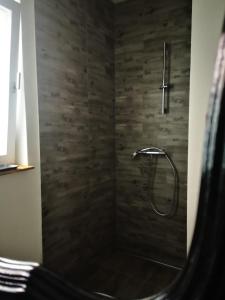 a bathroom with a shower with a shower head at Apartments Netty in Dramalj