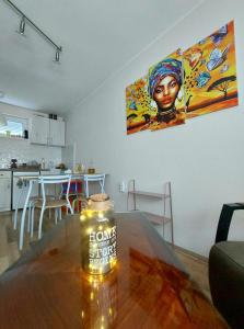 a bottle of beer sitting on a table in a kitchen at Sunny Funny House in Čačak