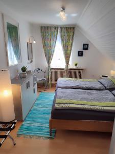 a bedroom with a bed and a desk and a window at Haus Wander-Lust in Lauterbach +122 photos