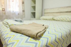 a bed with a blanket sitting on top of it at Vintage Blue in Kumanovo