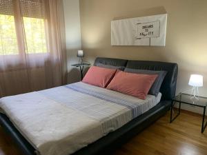 a bed with two pink pillows on it in a bedroom at Home53 in Arezzo