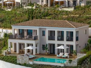 an aerial view of a villa with a swimming pool at Angsana Corfu Resort & Spa in Benitses +37 photos