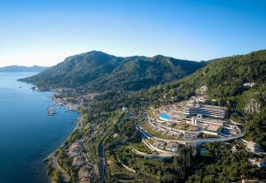 an aerial view of a resort on a hill next to the water at Angsana Corfu Resort & Spa in Benitses