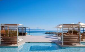 a resort with a pool and a view of the water at Angsana Corfu Resort & Spa in Benitses
