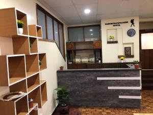 an office with a reception desk and shelves at Nairobi Backpackers Hostel in Nairobi