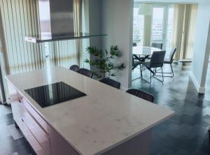 a kitchen and dining room with a table and chairs at Luxury Three-Bedroom Penthouse- By Resify in Nottingham