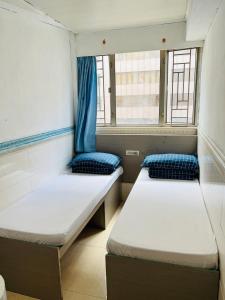 Postel nebo postele na pokoji v ubytování 嘉應賓館HAKKAS GUEST House