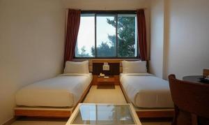 FabHotel Prime Rester Select - in chakan客房内的一张或多张床位