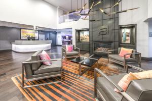 a lobby with several chairs and a fireplace at Aloft San Jose Cupertino in San Jose