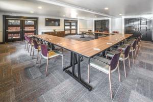 a large conference room with a large wooden table and chairs at Aloft San Jose Cupertino in San Jose