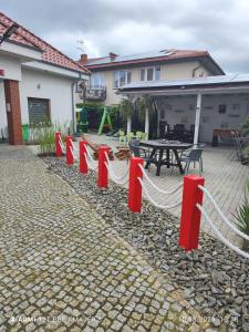 a row of red barriers in front of a house at Villa Zosia in Rowy
