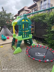 a playground with a hula hoop in a yard at Villa Zosia in Rowy