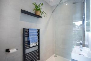 Un baño con ducha, lavabo e inodoro. en The Hay Loft, en Sidmouth 12 fotos más