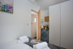 a bedroom with a bed with towels on it at The Hay Loft in Sidmouth