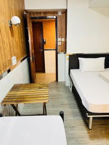 Postel nebo postele na pokoji v ubytování 嘉應賓館HAKKAS GUEST House