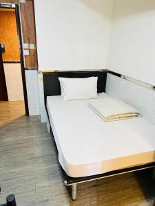 Postel nebo postele na pokoji v ubytování 嘉應賓館HAKKAS GUEST House