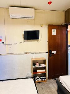 TV a/nebo společenská místnost v ubytování 嘉應賓館HAKKAS GUEST House