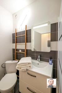 a bathroom with a toilet and a sink and a mirror at "La Dolce Vita" Studio cosy avec balcon in Pau