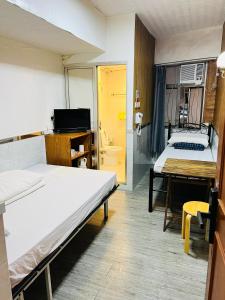 Postel nebo postele na pokoji v ubytování 嘉應賓館HAKKAS GUEST House