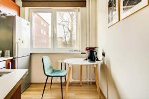 a small kitchen with a table and a chair at Cozy flat near city center and airport. FREE PARKING in Vilnius
