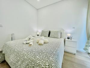 a bedroom with a white bed with towels on it at Âncora - Beach 50m - Sea View Terrace in Armação de Pêra