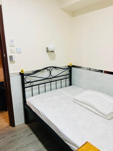 Postel nebo postele na pokoji v ubytování 嘉應賓館HAKKAS GUEST House
