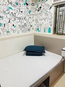 Postel nebo postele na pokoji v ubytování 嘉應賓館HAKKAS GUEST House