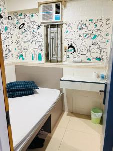 Postel nebo postele na pokoji v ubytování 嘉應賓館HAKKAS GUEST House