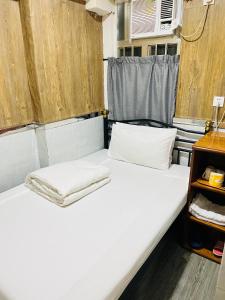 Postel nebo postele na pokoji v ubytování 嘉應賓館HAKKAS GUEST House