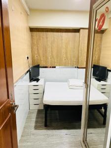 Postel nebo postele na pokoji v ubytování 嘉應賓館HAKKAS GUEST House