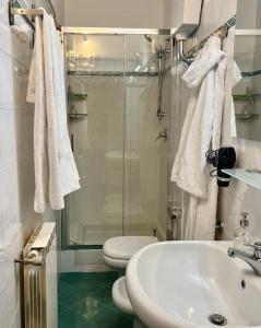 a bathroom with a shower and a toilet and a sink at Sweet Home Florence in Florence
