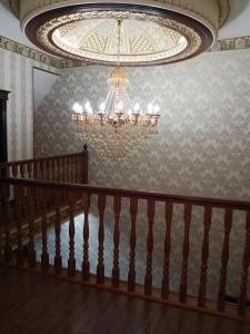 a chandelier in a room with a staircase at Shafran B&B in Bukhara
