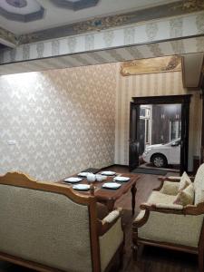 una sala da pranzo con tavolo e 2 sedie di Shafran B&B a Bukhara