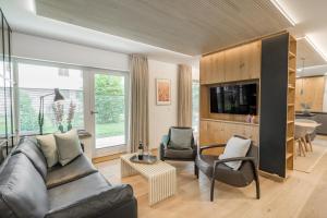 ein Wohnzimmer mit einem Sofa und einem TV in der Unterkunft Edelbude in Oberstdorf