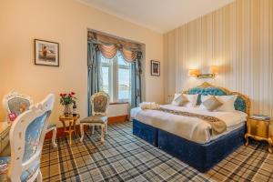a hotel room with a bed and a window at Muthu Alexandra Hotel in Oban