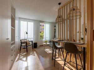 a kitchen with a table and chairs in a room at Nice studio in neighbourhood Ibiza-NARV72 in Madrid