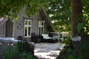 a patio with a couch and chairs on a house at Central Nicolas Apartment Nr6 Stavanger 4 rooms in Stavanger