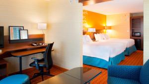 a hotel room with a bed and a desk at Fairfield Inn & Suites by Marriott Atlanta Gwinnett Place in Duluth