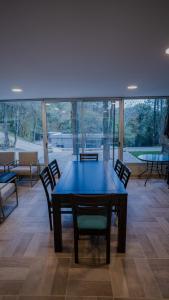 a dining room with a blue table and chairs at Eco lodge de la selva in San Salvador de Jujuy