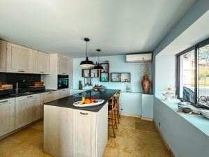 a kitchen with a island with a bowl of fruit on it at "Grand Bleu" Villa direkt am Meer in La Seyne-sur-Mer +15 photos