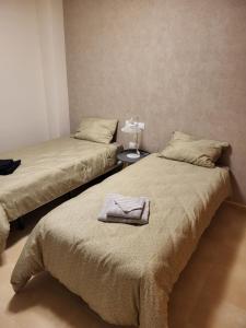 - 2 lits jumeaux dans une chambre avec une table de nuit dans l'établissement Hacienda de Alamo / Casa Veraneo, à Fuente-Álamo de Murcia