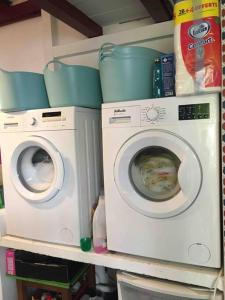 two washing machines are sitting on a shelf at Appartement en rez de jardin in Ciboure