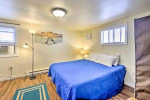 a bedroom with a blue bed with a blue blanket at The Starfish Hampton Cottage Walk to Beach! in Hampton