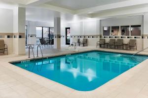 a large pool with blue water in a hotel room at Courtyard by Marriott Jackson in Jackson