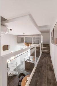 a room with white walls and a staircase with a table at Beautiful and cosy flat La Latina-Rastro-IZQ in Madrid