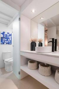 a white bathroom with a sink and a toilet at Beautiful and cosy flat La Latina-Rastro-IZQ in Madrid