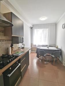 a kitchen with a table and a dining room at Guest House in Mykolaiv in Mykolaiv